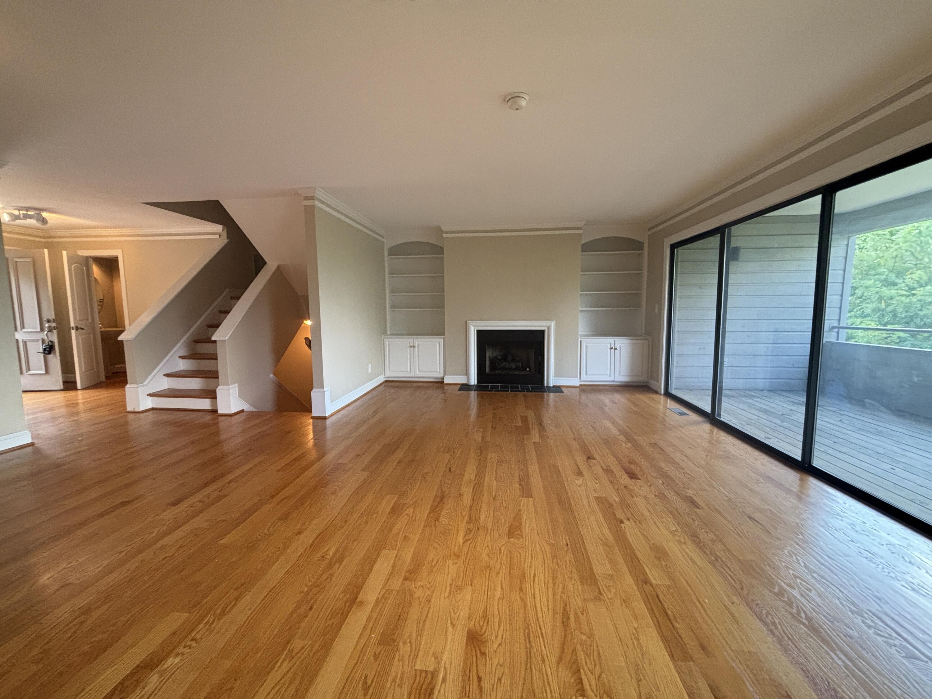 4978 Hunting Hills Circle Roanoke, VA 24018 - Photo 2 of 24 a view of empty room with wooden floor and fireplace