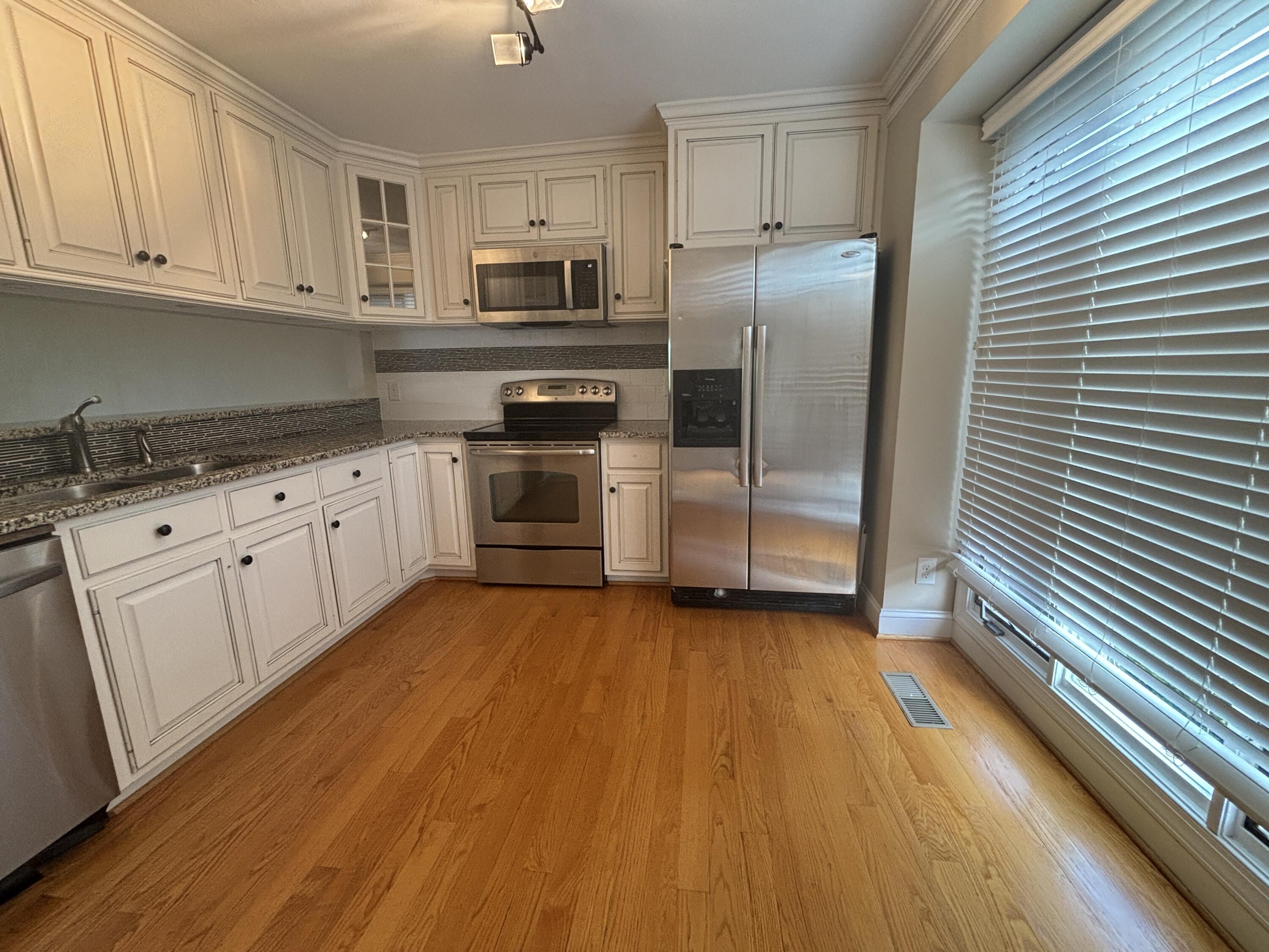 4978 Hunting Hills Circle Roanoke, VA 24018 - Photo 5 of 24 a kitchen with granite countertop a refrigerator and a stove top oven