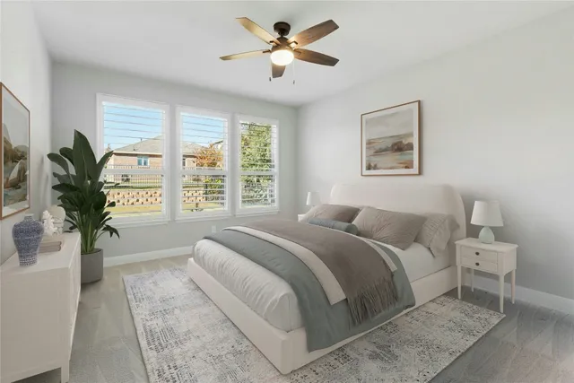 a bedroom with a large bed plant and a window
