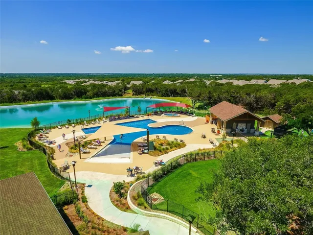 an aerial view of a house with outdoor space swimming pool patio and outdoor seating
