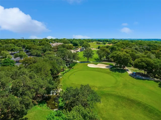 a view of a big yard with large trees