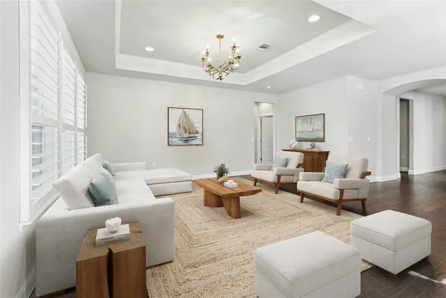 a living room with furniture and a chandelier
