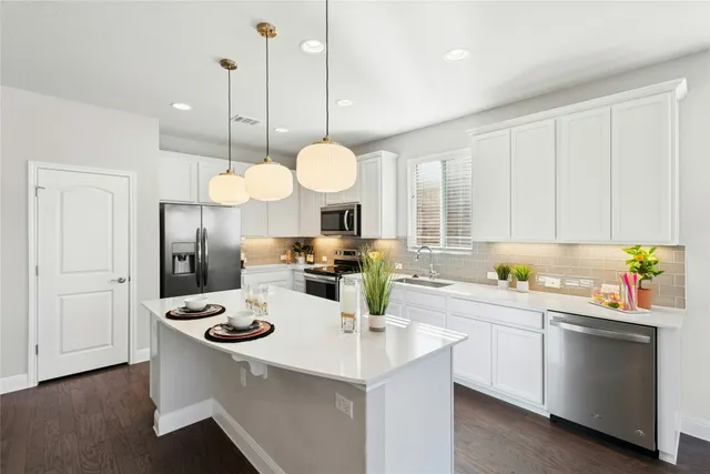 a kitchen with a sink a stove and cabinets