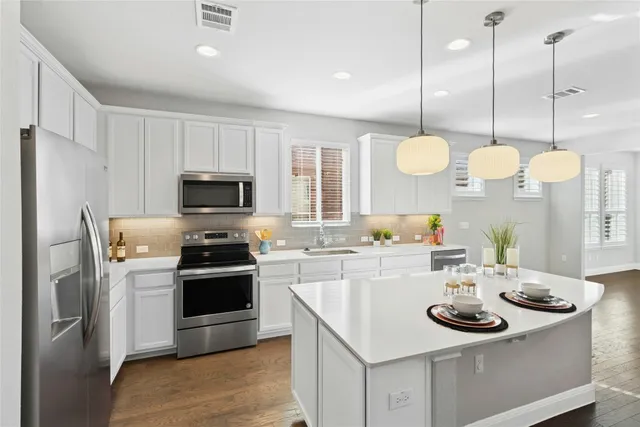 a kitchen with a sink stove and microwave