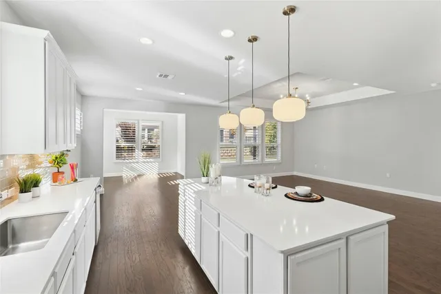 a very nice looking dining room with a chandelier furniture and a window