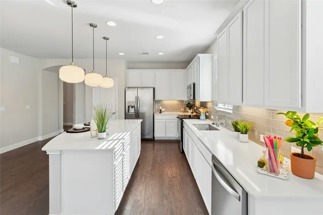 a kitchen with counter top space and stainless steel appliances