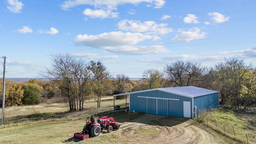 831 Union Hill Road Ennis, TX 75119 - Photo 3 of 38 a view of a backyard with barn and a stove