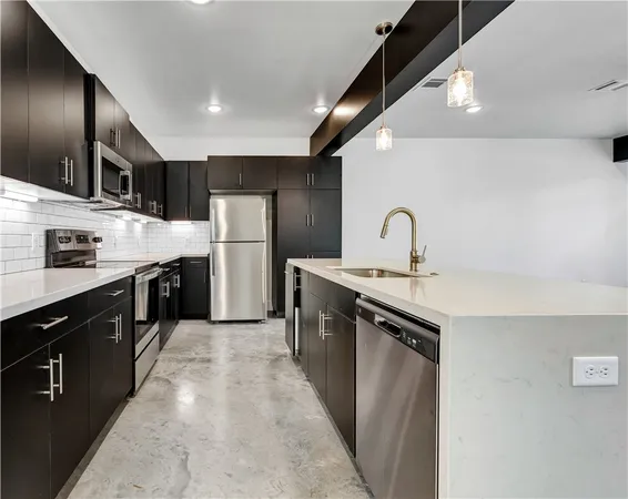 a kitchen with refrigerator a sink and cabinets