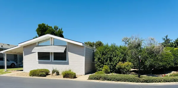 a front view of a house with plants