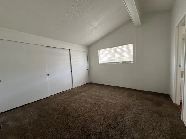 an empty room with a empty space and window