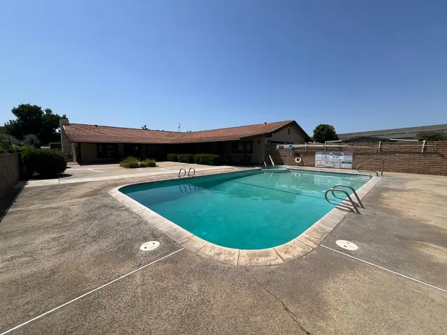a view of a swimming pool with seating area