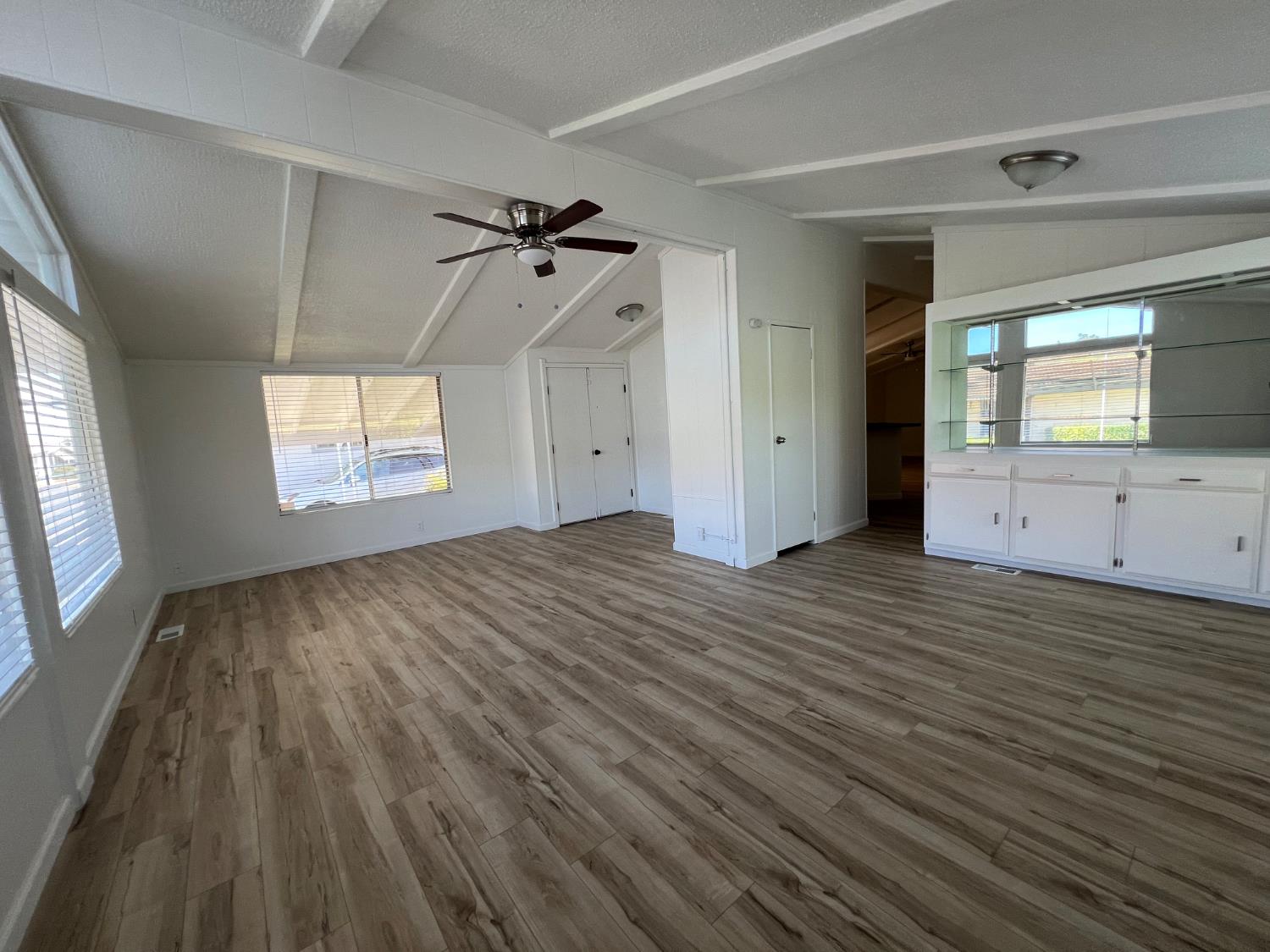 2240 Golden Oak Lane, Unit 134 Merced, CA 95341 - Photo 9 of 29 a view of an empty room with wooden floor and a window