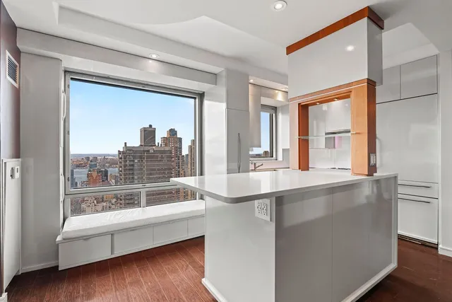 a large white kitchen with a large window