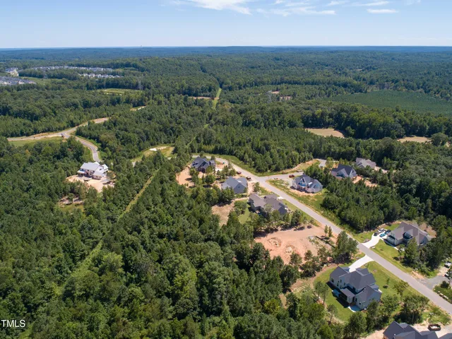 an aerial view of a houses with a yard