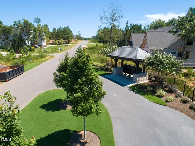 a view of a garden with a table and chairs under an umbrella