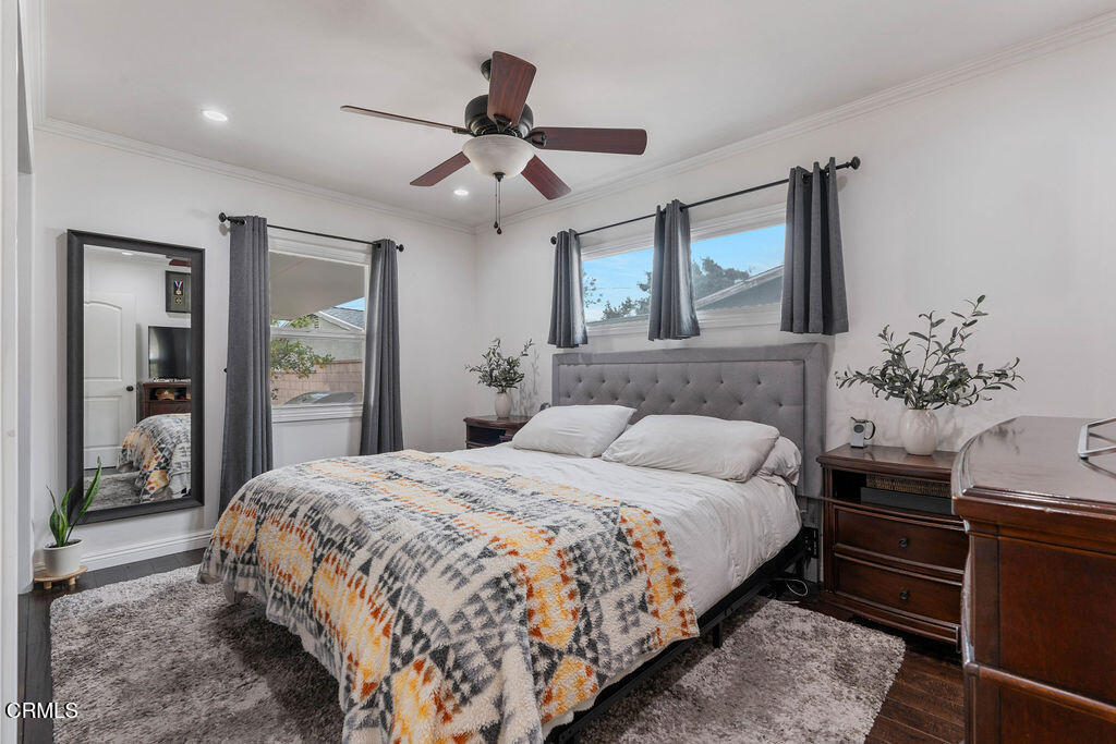 719 North Bradish Avenue San Dimas, CA 91773 - Photo 12 of 22 a bedroom with a large bed and a chandelier