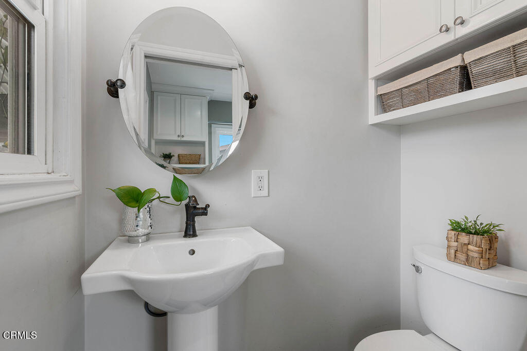 719 North Bradish Avenue San Dimas, CA 91773 - Photo 8 of 22 a bathroom with a toilet sink and mirror