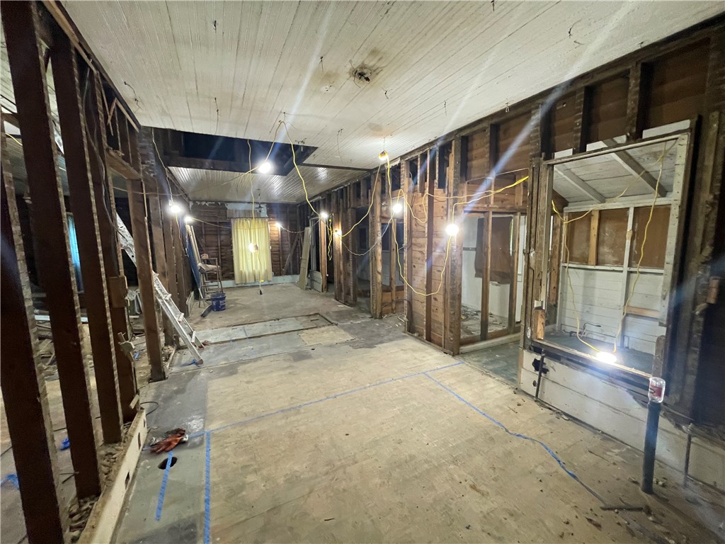 171 River Ridge Road Seneca, SC 29672 - Photo 5 of 22 Exposed wood framing outlines the future open-concept living space, illuminated by temporary construction lighting.