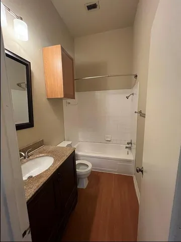 a bathroom with a bathtub sink vanity and mirror