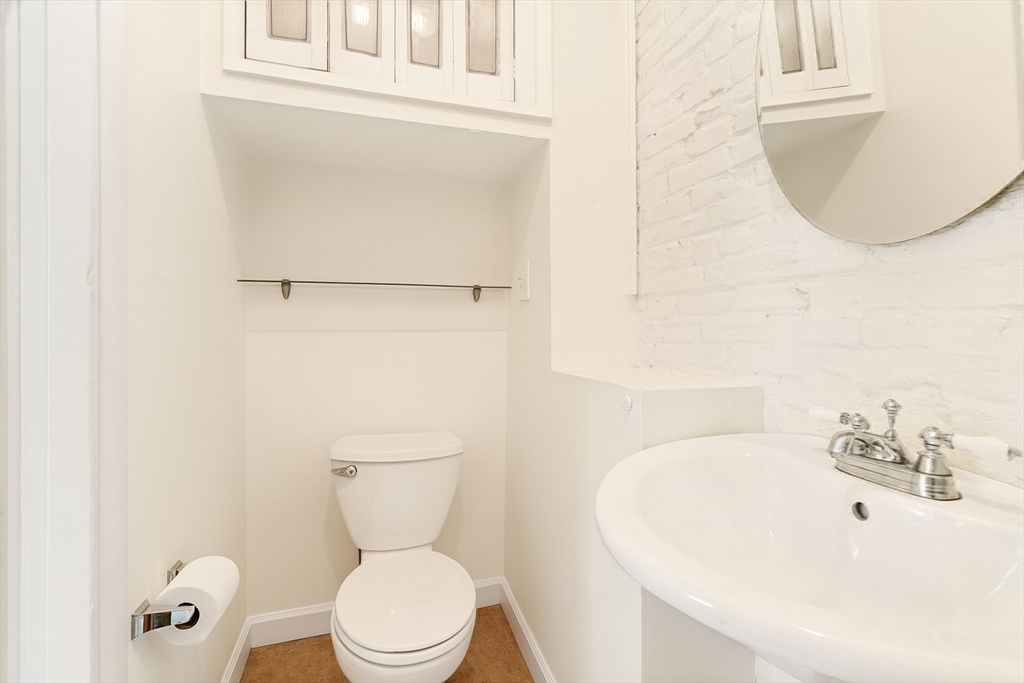 39 Revere Street, Unit 6 Boston, MA 02114 - Photo 22 of 22 a bathroom with a sink a toilet and a mirror