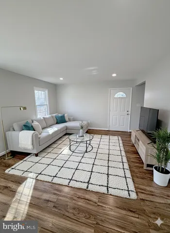 a living room with furniture and a rug