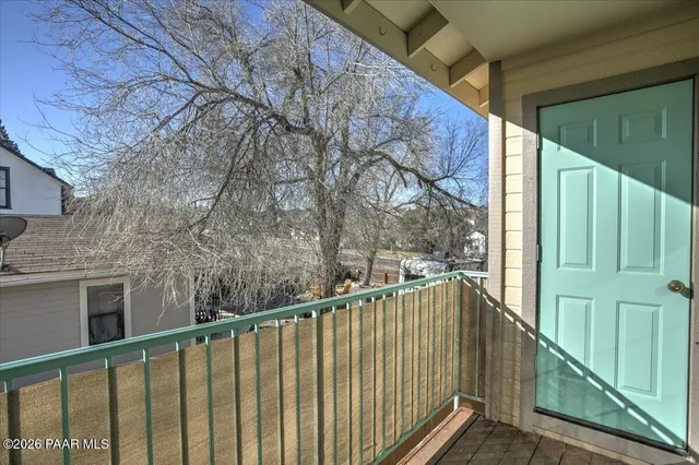 en empty room with white walls and fan