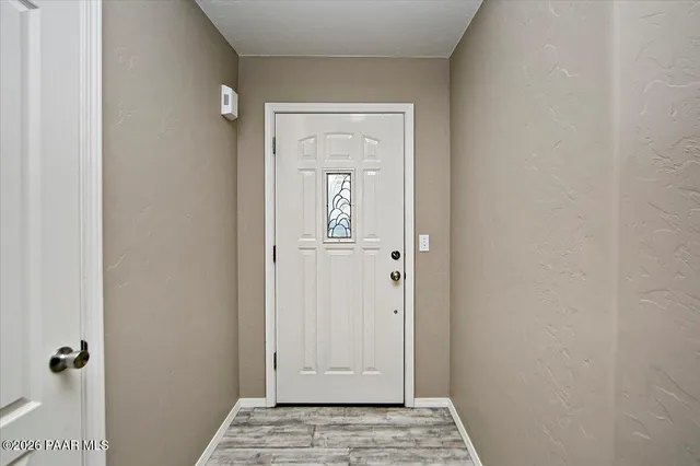 a view of kitchen with stainless steel appliances granite countertop a stove and a refrigerator