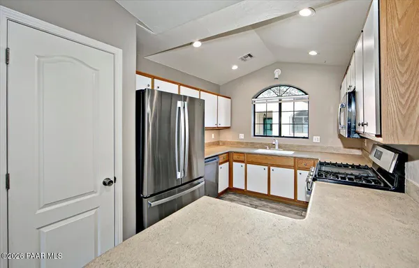 a kitchen with a stove a sink and a microwave