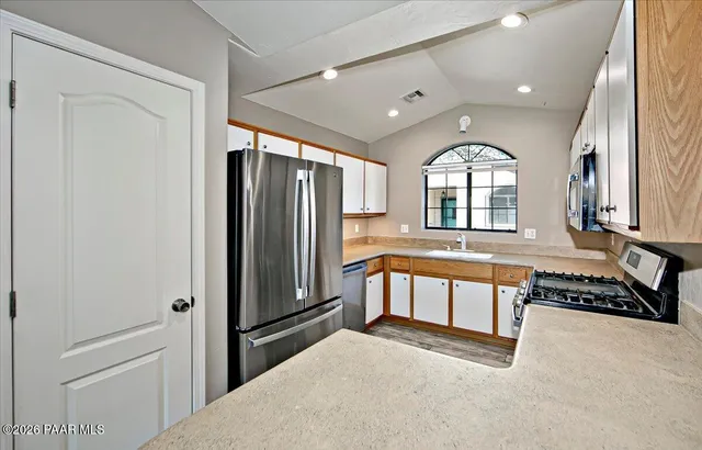 a kitchen with a stove a sink and a microwave