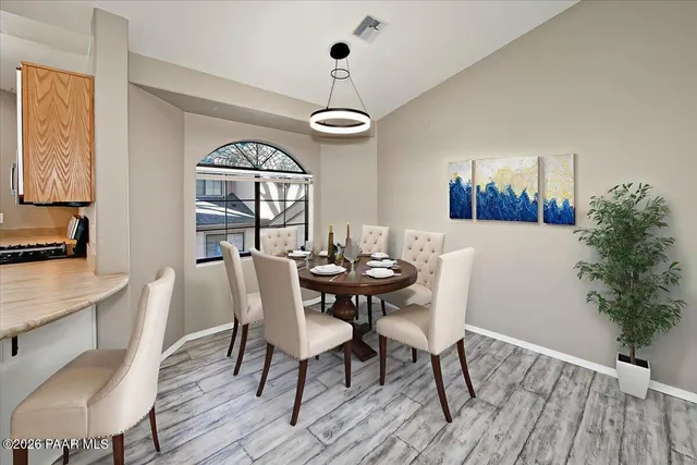 a view of a room with wooden floor cabinet and a window