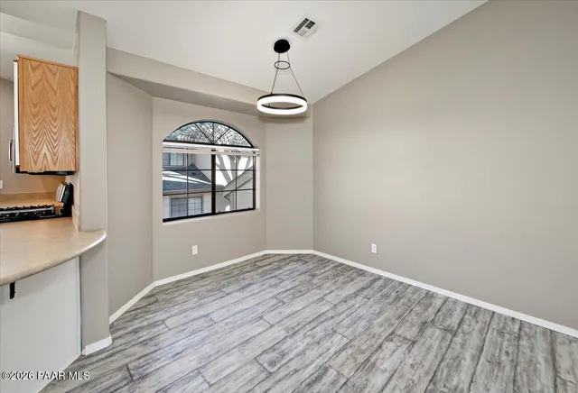 a living room with furniture a flat screen tv and a large window