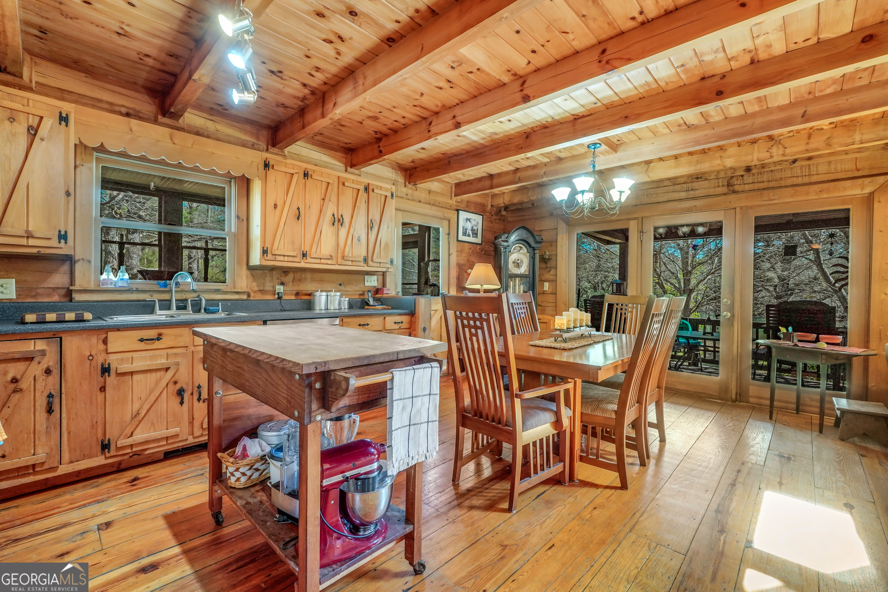 330 Country Kitchen Road Barnesville, GA 30204 - Photo 25 of 64 a open kitchen with stainless steel appliances granite countertop a stove a refrigerator a dining table and chairs with wooden floor