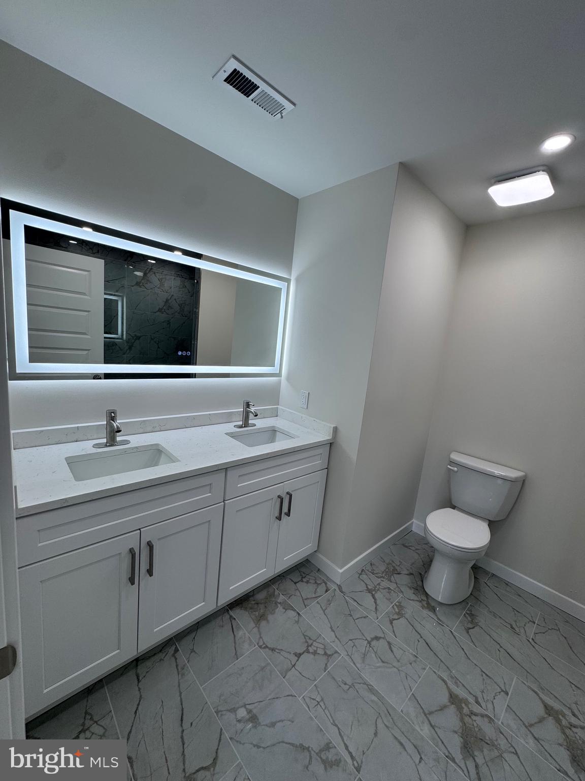 229 Ridge Avenue Blackwood, NJ 08012 - Photo 20 of 24 a bathroom with a toilet sink double vanity and mirror