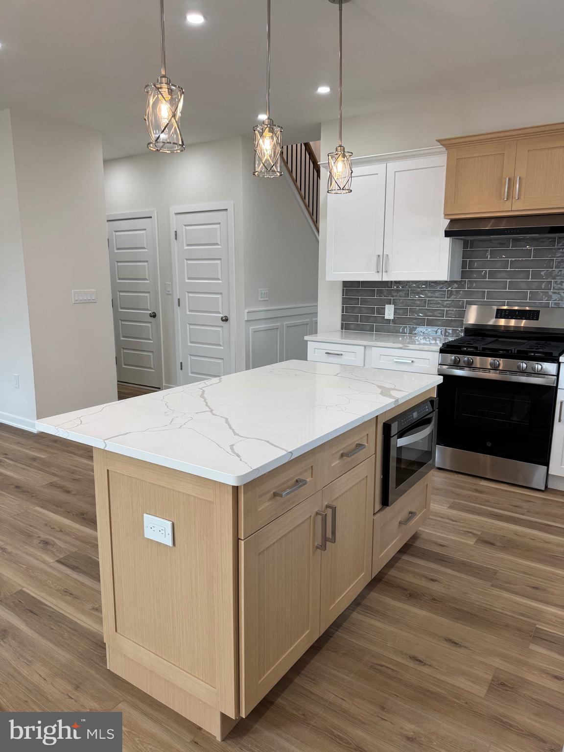 229 Ridge Avenue Blackwood, NJ 08012 - Photo 9 of 24 a kitchen that has a stove a sink and a wooden floor