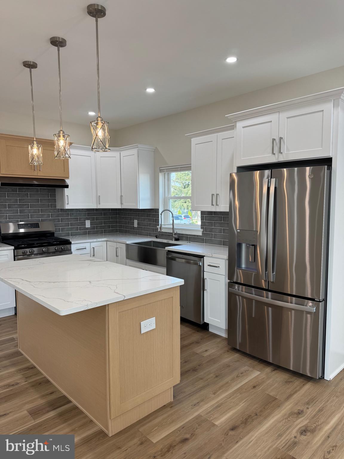 229 Ridge Avenue Blackwood, NJ 08012 - Photo 10 of 24 a kitchen with stainless steel appliances granite countertop a refrigerator a sink dishwasher a stove and white cabinets with wooden floor