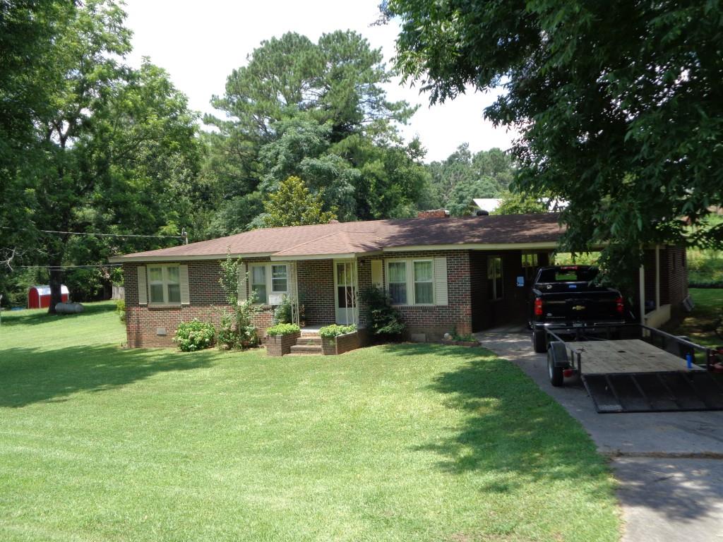 1036 Prior Station Road Cedartown, GA 30125 - Photo 1 of 1 a view of a house with a yard patio and fire pit
