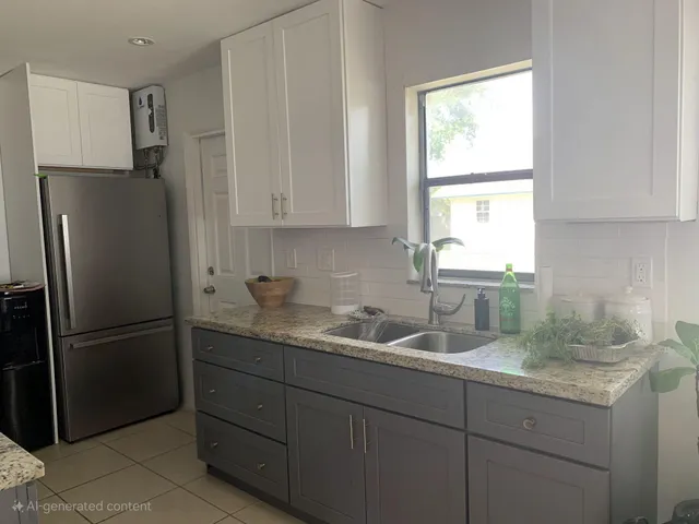 a kitchen with stainless steel appliances granite countertop a refrigerator and a sink