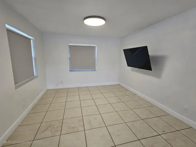 a view of a livingroom with an empty space and a window