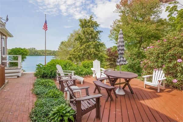 242 Barker Road Wareham, MA 02538 - Photo 18 of 30 a view of a patio with table and chairs potted plants with wooden floor and fence