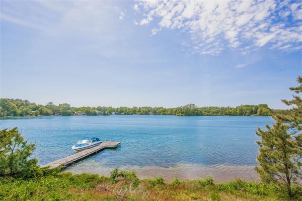 242 Barker Road Wareham, MA 02538 - Photo 2 of 30 a view of a lake with houses in the back