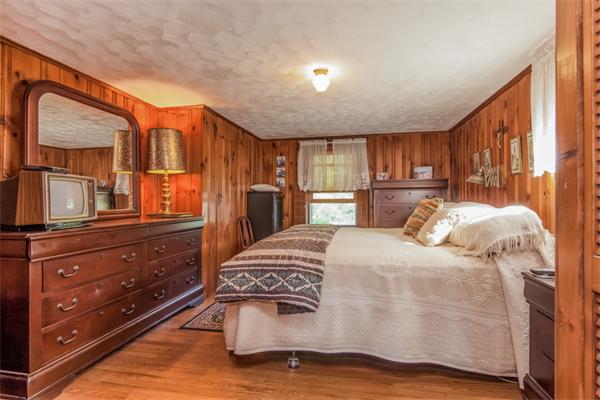 242 Barker Road Wareham, MA 02538 - Photo 21 of 30 a bedroom with a bed and wooden floor