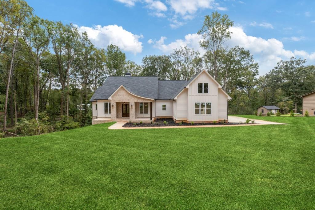 2001 Epperson Road Canton, GA 30115 - Photo 2 of 76 a front view of a house with yard and green space