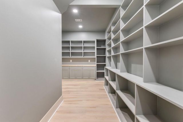 an empty room with a window and a ceiling fan