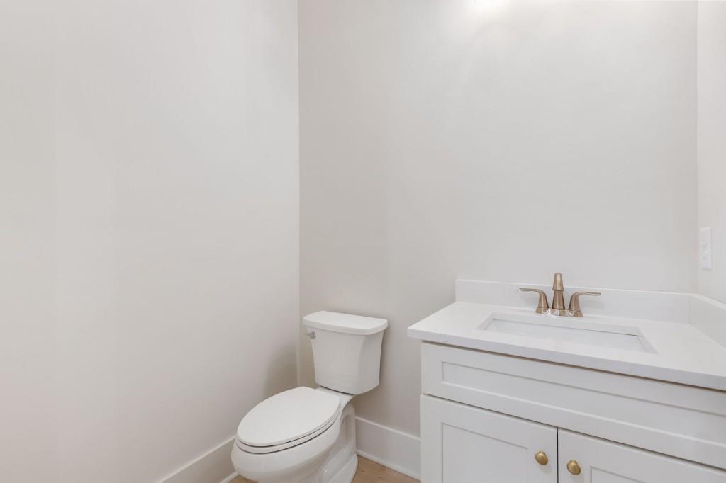 2001 Epperson Road Canton, GA 30115 - Photo 25 of 76 a bathroom with a toilet a sink and mirror