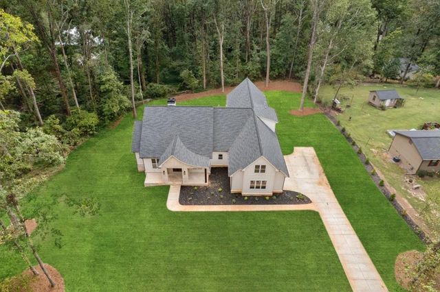 front view of a brick house with a yard