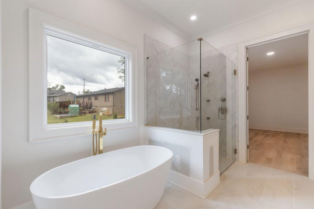 2001 Epperson Road Canton, GA 30115 - Photo 32 of 76 a bathroom with a bathtub and a shower