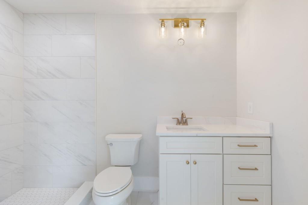 2001 Epperson Road Canton, GA 30115 - Photo 44 of 76 a white toilet sitting next to a bathroom sink