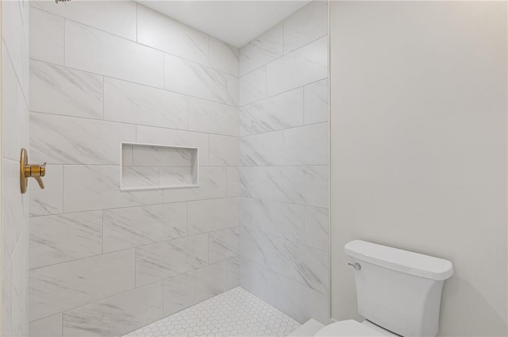 2001 Epperson Road Canton, GA 30115 - Photo 67 of 76 a bathroom with a toilet and a shower