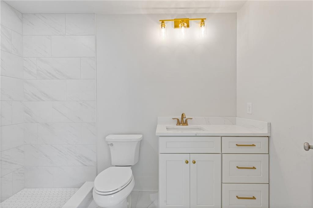 2001 Epperson Road Canton, GA 30115 - Photo 69 of 76 a bathroom with a sink a toilet and vanity