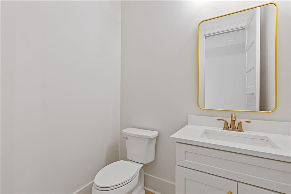 2001 Epperson Road Canton, GA 30115 - Photo 70 of 76 a bathroom with a toilet a sink and mirror